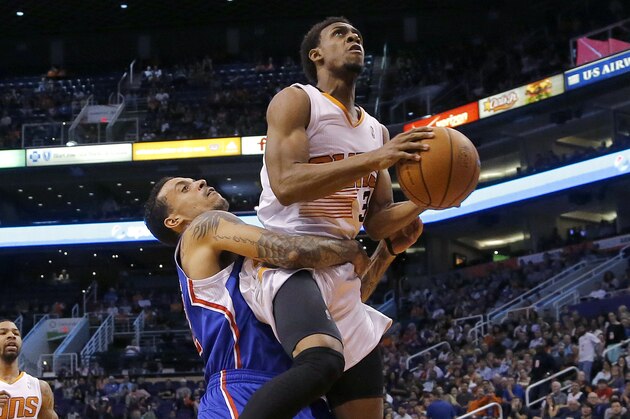 Los Angeles Clippers' Matt Barnes grabs Phoenix Suns' Ish Smith to prevent him from scoring during the second half of an NBA basketball game, Tuesday, March 4, 2014, in Phoenix. The Clippers won 104-96. (AP Photo/Matt York)