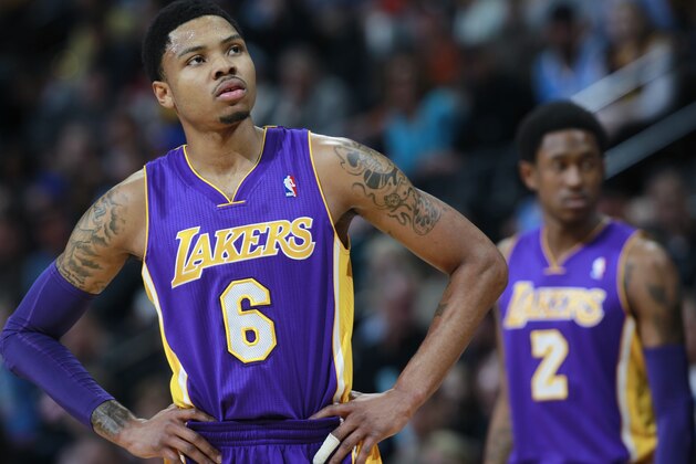 Los Angeles Lakers guard Kent Bazemore, front, looks on against the Denver Nuggets as guard MarShon Brooks, back, checks in to play in the first quarter of an NBA basketball game in Denver on Friday, March 7, 2014. (AP Photo/David Zalubowski) Los Angeles Lakers guard Kent Bazemore, front, looks on against the Denver Nuggets as guard MarShon Brooks, back, checks in to play in the first quarter of an NBA basketball game in Denver on Friday, March 7, 2014. (AP Photo/David Zalubowski)