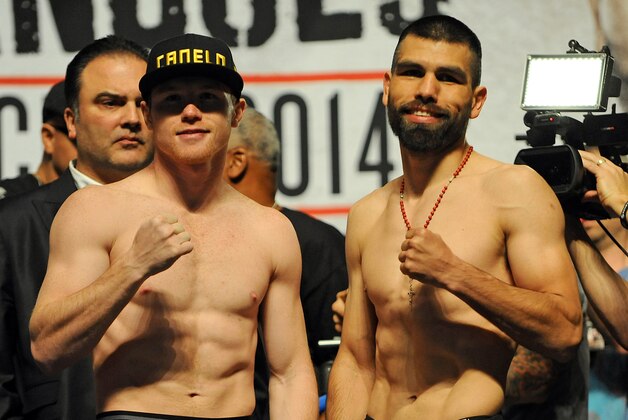 Mar 7, 2014; Las Vegas, NV, USA; Saul Canelo Alvarez (left) and Alfredo Angulo pose for photographers during a weigh-in before their super welterweight bout at MGM Grand Garden Arena. Mandatory Credit: Stephen R. Sylvanie-USA TODAY Sports