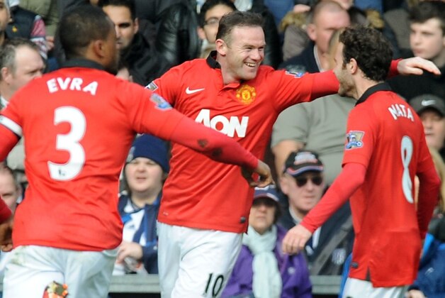 Manchester United's Wayne Rooney celebrates with Juan mata, right, and Patrice Evra after scoring against West Brom during the English Premier League soccer match between West Bromwich Albion and Manchester United at The Hawthorns Stadium in West Bromwich, England, Saturday, March 8, 2014.  (AP Photo/Rui Vieira)