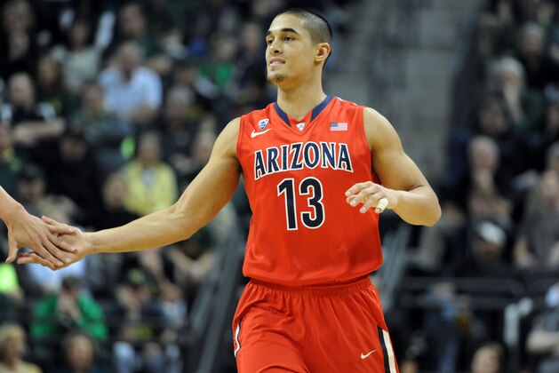 EUGENE, OR - MARCH 8:  Nick Johnson #13 of the Arizona Wildcats is greeted at the bench during the first half of the game against the Oregon Ducks at Matthew Knight Arena on March 8, 2014 in Eugene, Oregon.  (Photo by Steve Dykes/Getty Images)
