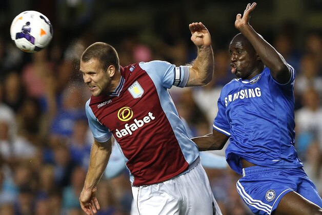 Chelsea's Demba Ba, right, vies for the ball with Aston Villa's Ron Vlaar during the English Premier League soccer match between Chelsea and Aston Villa at Stamford Bridge Stadium in London, Wednesday, Aug. 21, 2013. (AP Photo/Kirsty Wigglesworth)