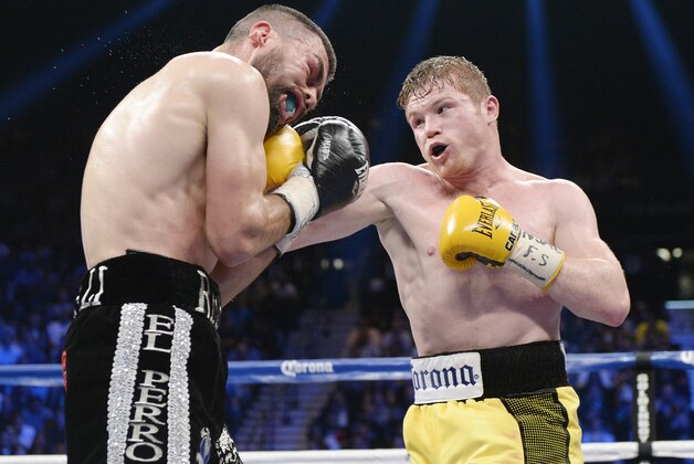 LAS VEGAS, NV - MARCH 8: Canelo Alvarez throws a punch against Alfredo Angulo (L) during the non-title, 12-round super welterweight bout at the MGM Grand Garden March 8, 2014, in Las Vegas, Nevada. Alvarez won by technical knock out after the referee stopped the fight in the 10th round. (Photo by Kevork Djansezian/Getty Images) LAS VEGAS, NV - MARCH 8: Canelo Alvarez throws a punch against Alfredo Angulo (L) during the non-title, 12-round super welterweight bout at the MGM Grand Garden March 8, 2014, in Las Vegas, Nevada. Alvarez won by technical knock out after the referee stopped the fight in the 10th round. (Photo by Kevork Djansezian/Getty Images)