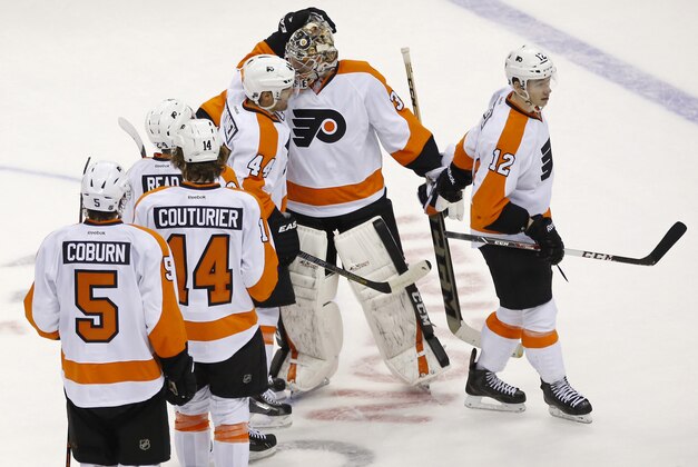 Mar 2, 2014; Washington, DC, USA; Philadelphia Flyers goalie Steve Mason (35) celebrates with teammates after their game against the Washington Capitals at Verizon Center. The Flyers won 5-4 in overtime. Mandatory Credit: Geoff Burke-USA TODAY Sports