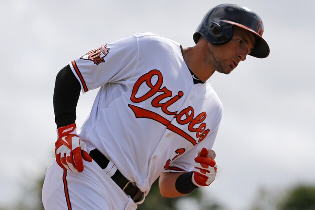 Baltimore Orioles' Ryan Flaherty (3) rounds second after hitting a two-run home run off Philadelphia Phillies starting pitcher A.J. Burnett in the second inning of an exhibition spring training baseball game in Sarasota, Fla., Friday, March 7, 2014. The Orioles won 15-4. (AP Photo/Gene J. Puskar)