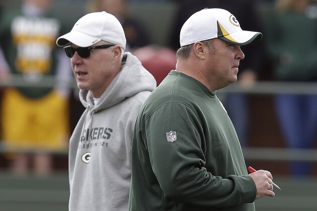 Green Bay Packers head coach Mike McCarthy talks to general manager Ted Thompson during NFL football training camp Sunday, July 28, 2013, in Green Bay, Wis. (AP Photo/Morry Gash)