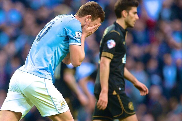 MANCHESTER, ENGLAND - MARCH 09:  Edin Dzeko of Man City looks dejected during the FA Cup Quarter-Final match between Manchester City and Wigan Athletic at the Etihad Stadium on March 9, 2014 in Manchester, England.  (Photo by Michael Regan/Getty Images)