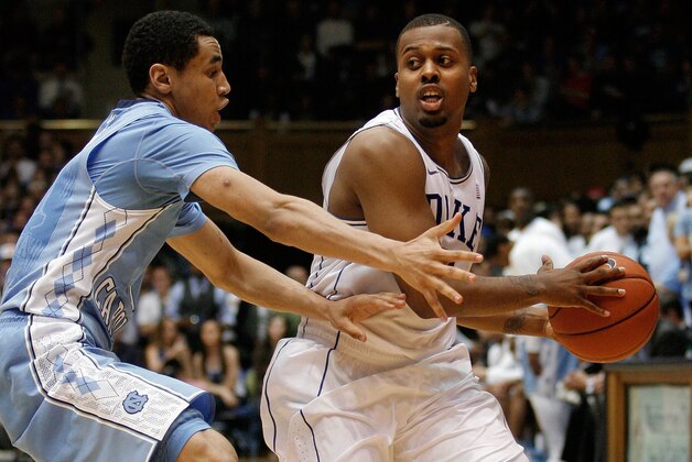 Mar 8, 2014; Durham, NC, USA; Duke Blue Devils guard Tyler Thornton (3) drives against North Carolina Tar Heels guard Marcus Paige (5) at Cameron Indoor Stadium. Mandatory Credit: Mark Dolejs-USA TODAY Sports