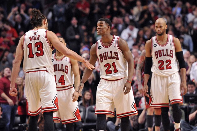 Mar 9, 2014; Chicago, IL, USA; Chicago Bulls center Joakim Noah (13) celebrates a play with shooting guard Jimmy Butler (21) during the second half against the Miami Heat at the United Center. The Bulls beat the Heat 95-88. Mandatory Credit: Rob Grabowski-USA TODAY Sports