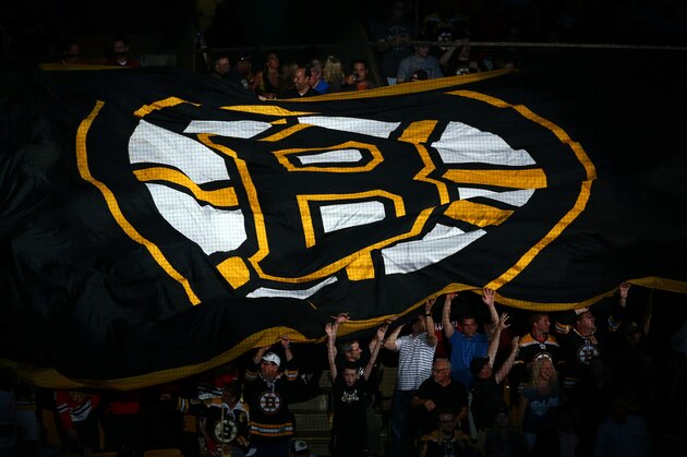 BOSTON, MA - JUNE 24:  Boston Bruins fans hold a giant flag with the Boston Logo on it prior Game Six of the 2013 NHL Stanley Cup Final against the Chicago Blackhawks at TD Garden on June 24, 2013 in Boston, Massachusetts.  (Photo by Elsa/Getty Images)