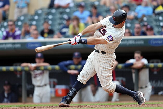 Aug 14, 2013; Minneapolis, MN, USA; Minnesota Twins catcher Joe Mauer (7) hits a home run in the tenth inning against the Cleveland Indians at Target Field. The Indians won 9-8 in 12 innings. Mandatory Credit: Jesse Johnson-USA TODAY Sports