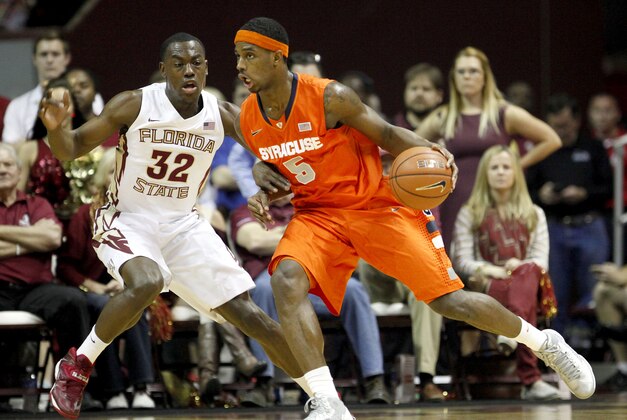 Mar 9, 2014; Tallahassee, FL, USA; Syracuse Orange forward C.J. Fair (5) dribbles around Florida State Seminoles guard Montay Brandon (32) during the first half at Donald L. Tucker Center. Syracuse defeated Florida State 74-58. Mandatory Credit: Matt Stamey-USA TODAY Sports
