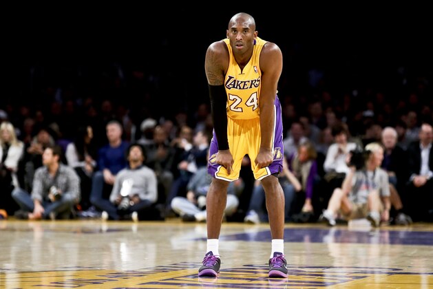 Los Angeles Lakers guard Kobe Bryant watches his team during an NBA basketball game against the Phoenix Suns in Los Angeles, Tuesday, Dec. 10, 2013. (AP Photo/Chris Carlson)