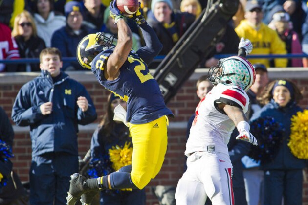 Michigan wide receiver Jeremy Gallon (21) makes a touchdown catch over Ohio State safety C.J. Barnett (4) during the second quarter of an NCAA college football game in Ann Arbor, Mich., Saturday, Nov. 30, 2013. (AP Photo/Tony Ding)