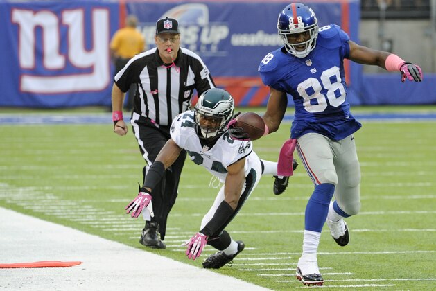 Philadelphia Eagles cornerback Bradley Fletcher (24) chases New York Giants' Hakeem Nicks (88) out of bounds during the second half of an NFL football game Sunday, Oct. 6, 2013, in East Rutherford, N.J.  (AP Photo/Bill Kostroun)