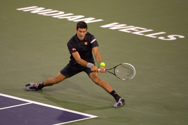 Novak Djokovic, of Serbia, returns a shot to Victor Hanescu, of Romania, during their match at the BNP Paribas Open tennis tournament, Sunday, March 9, 2014, in Indian Wells, Calif. (AP Photo/Mark J. Terrill)
