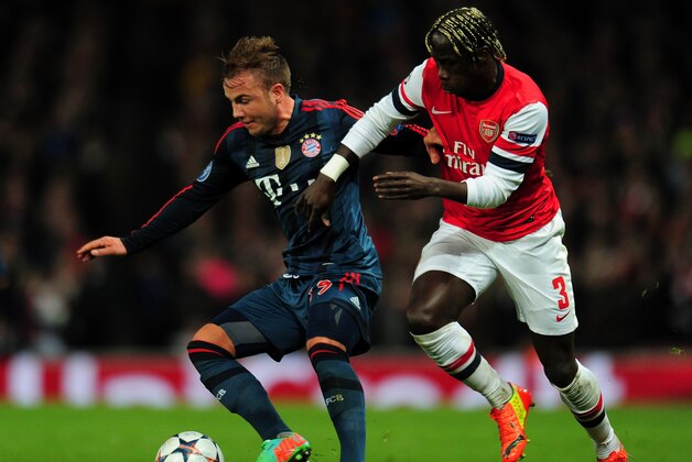 LONDON, ENGLAND - FEBRUARY 19:  Patrick Weihrauch of Bayern Muenchen holds off a challenge from Bacary Sagna of Arsenal during the UEFA Champions League Round of 16 first leg match between Arsenal and FC Bayern Muenchen at Emirates Stadium on February 19, 2014 in London, England.  (Photo by Shaun Botterill/Getty Images)