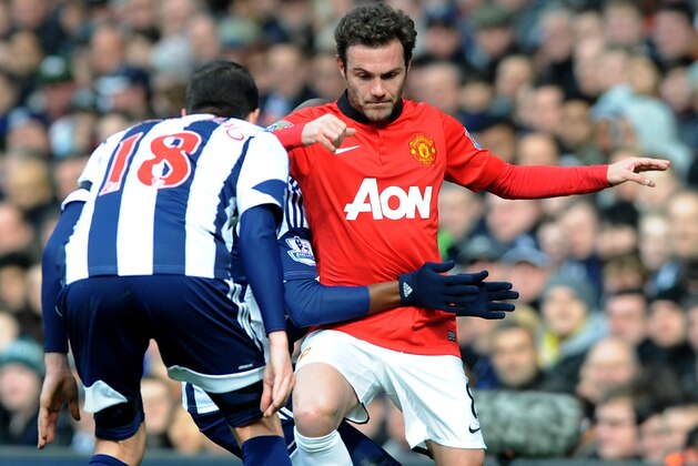 Manchester United's Juan Mata is held back by West Brom's Youssuf Mulumbu during the English Premier League soccer match between West Bromwich Albion and Manchester United at The Hawthorns Stadium in West Bromwich, England, Saturday, March 8, 2014. (AP Photo/Rui Vieira) Manchester United's Juan Mata is held back by West Brom's Youssuf Mulumbu during the English Premier League soccer match between West Bromwich Albion and Manchester United at The Hawthorns Stadium in West Bromwich, England, Saturday, March 8, 2014. (AP Photo/Rui Vieira)