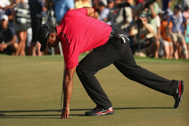 DORAL, FL - MARCH 09:  Tiger Woods collects his golf ball during the final round of the World Golf Championships-Cadillac Championship at Trump National Doral on March 9, 2014 in Doral, Florida.  (Photo by Mike Ehrmann/Getty Images)