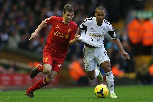 LIVERPOOL, ENGLAND - FEBRUARY 23:  Jon Flanagan of Liverpool battles with Wayne Routledge of Swansea City during the Barclays Premier League match between Liverpool and Swansea City at Anfield on February 23, 2014 in Liverpool, England.  (Photo by Clive Brunskill/Getty Images)