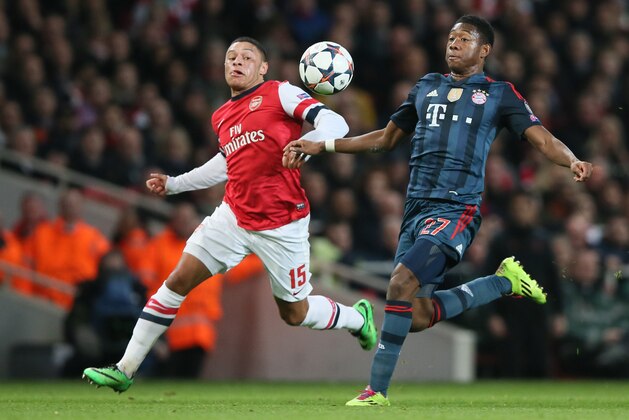 Arsenal's Alex Oxlade-Chamberlain, left, challenges Bayern's David Alaba during a Champions League, round of 16, first leg soccer match between Arsenal and Bayern Munich at the Emirates stadium in London, Wednesday, Feb. 19, 2014. (AP Photo/Alastair Grant)
