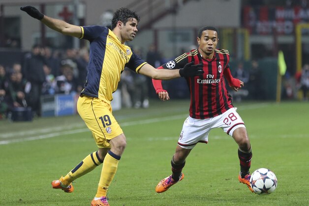 AC Milan midfielder Urby Emanuelson, of the Netherlands, vies for the ball with Atletico Madrid Brazilian forward Diego Costa, left, during a Champions League, round of 16, first leg, soccer match between AC Milan and Atletico Madrid at the San Siro stadium in Milan, Italy, Wednesday, Feb. 19, 2014. (AP Photo/Antonio Calanni)