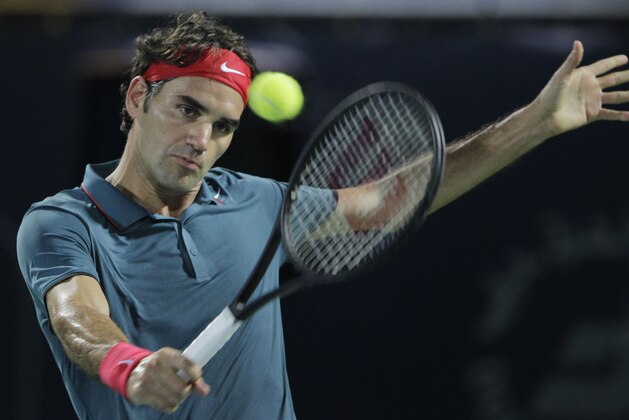 Roger Federer of Switzerland returns the ball to Tomas Berdych of Czech Republic during the final match of the Dubai Duty Free Tennis Championships in Dubai, United Arab Emirates, Saturday, March 1, 2014. (AP Photo/Kamran Jebreili)