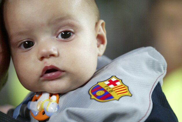 BARCELONA, SPAIN - OCTOBER 22:  A fan of FC Barcelona brings their baby to the match between FC Barcelona and Osasuna of the Spanish Primera Liga on October 22, 2005 at the Camp Nou stadium in Barcelona, Spain. Barcelona won 3-0.  (Photo by Luis Bagu/Getty Images)