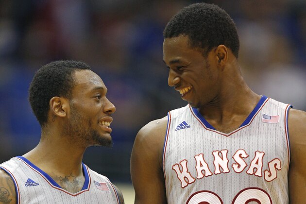 LAWRENCE, KS - FEBRUARY 8: Naadir Tharpe #10 and Andrew Wiggins #22 of the Kansas Jayhawks talk as they walk back onto the court after a time out during a game against the West Virginia Mountaineers in the second half at Allen Fieldhouse on February 8, 2014 in Lawrence, Kansas. (Photo by Ed Zurga/Getty Images)
