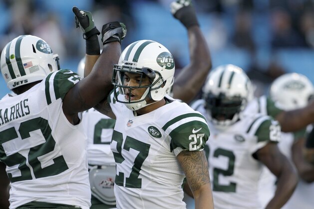 New York Jets' David Harris (52) and Dee Milliner (27) join teammates greeting each other before an NFL football game against the Carolina Panthers in Charlotte, N.C., Sunday, Dec. 15, 2013. The Panthers won 30-20. (AP Photo/Bob Leverone)