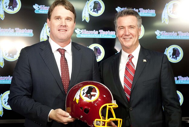 Jan 9, 2014; Ashburn, VA, USA; Washington Redskins head coach Jay Gruden and general manager Bruce Allen pose for a photo after a press conferences at Redskins Park Team Auditorium. Mandatory Credit: Brad Mills-USA TODAY Sports