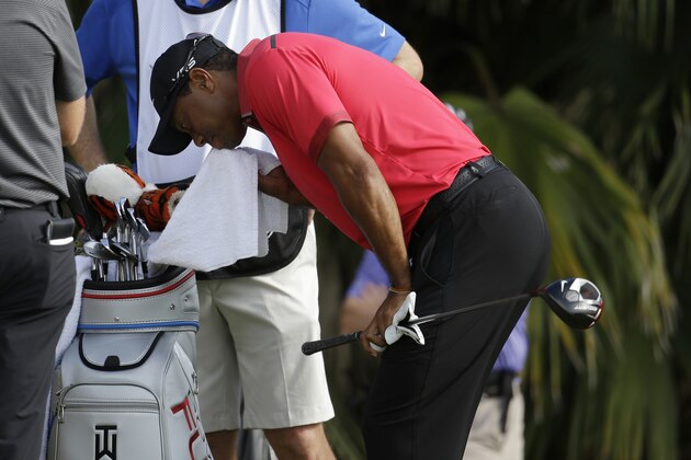 Tiger Woods wipes his face before teeing off on the 12th hole during the final round of the Cadillac Championship golf tournament Sunday, March 9, 2014, in Doral, Fla. (AP Photo/Lynne Sladky)