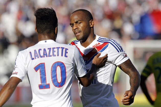 Lyon's Jimmy Briand, background centre,  celebrates with Alexandre Lacazette, back, after they scored a goal against Nantes during their French League One soccer match in Lyon, central France, Sunday, Sept. 22, 2013. (AP Photo/Laurent Cipriani)