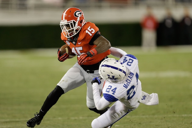 ATHENS, GA - NOVEMBER 23:  Running back J.J. Green #15 of the Georgia Bulldogs runs over defensive back Blake McClain #24 of the Kentucky Wildcats during the game at Sanford Stadium on November 23, 2013 in Athens, Georgia.  (Photo by Mike Zarrilli/Getty Images)