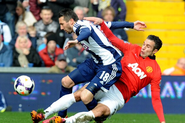 Manchester United's Robin van Persie   tackles West Brom's Morgan Amalfitano    during the English Premier League soccer match between West Bromwich Albion and Manchester United at The Hawthorns Stadium in West Bromwich, England, Saturday, March 8, 2014.  (AP Photo/Rui Vieira)