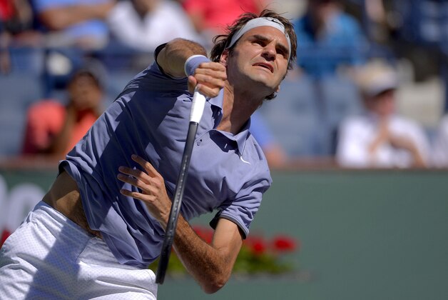 Roger Federer, of Switzerland, serves to Dmitry Tursunov, of Russia, during a third round match at the BNP Paribas Open tennis tournament, Monday, March 10, 2014 in Indian Wells, Calif. (AP Photo/Mark J. Terrill)
