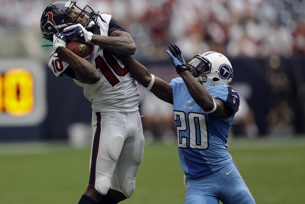 Houston Texans wide receiver DeAndre Hopkins (10) catches a pass as Tennessee Titans cornerback Alterraun Verner (20) defends during the fourth quarter of an NFL football game Sunday, Sept. 15, 2013, in Houston. (AP Photo/David J. Phillip)