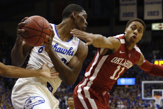 LAWRENCE, KS - FEBRUARY 24: Joel Embiid #21 of the Kansas Jayhawks grabs a rebound against Isaiah Cousins #11 of the Oklahoma Sooners in the first half at Allen Fieldhouse on February 24, 2014 in Lawrence, Kansas. (Photo by Ed Zurga/Getty Images)