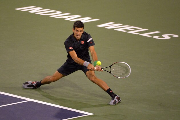 Novak Djokovic, of Serbia, returns a shot to Victor Hanescu, of Romania, during their match at the BNP Paribas Open tennis tournament, Sunday, March 9, 2014, in Indian Wells, Calif. (AP Photo/Mark J. Terrill)