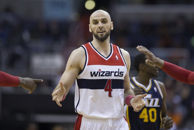 Washington Wizards center Marcin Gortat (4) is congratulated by teammates after scoring during the second half of an NBA basketball game against the Utah Jazz on Wednesday, March 5, 2014, in Washington. The Wizards defeated the Jazz 104-91. (AP Photo/ Evan Vucci)