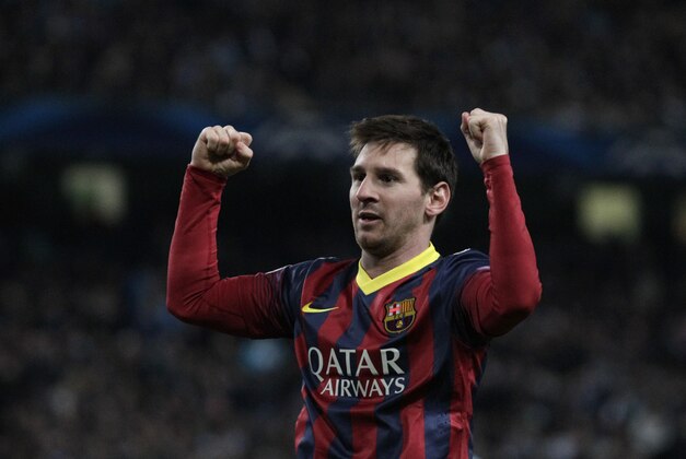 Barcelona's Lionel Messi celebrates after he scores the first goal of the game from a penalty during the Champions League first knock out round soccer match between Barcelona and Manchester City at the Etihad Stadium, Manchester, England, Tuesday Feb. 18, 2014. (AP Photo/Jon Super)