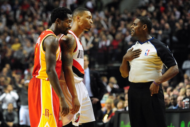 Dec 12, 2013; Portland, OR, USA; Houston Rockets point guard Patrick Beverley (2) and Portland Trail Blazers point guard Damian Lillard (0) speak with referee Leroy Richardson (20) during the fourth quarter of the game at the Moda Center. The Blazers won the game 111-104. Mandatory Credit: Steve Dykes-USA TODAY Sports