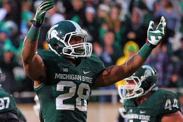 Nov 2, 2013; East Lansing, MI, USA; Michigan State Spartans linebacker Denicos Allen (28) reacts to a play during the 2nd half of a game against the Michigan Wolverines at Spartan Stadium. MSU won 29-6. Mandatory Credit: Mike Carter-USA TODAY Sports