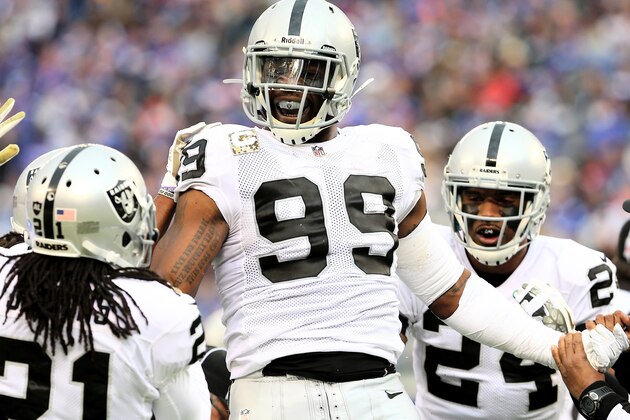 EAST RUTHERFORD, NJ - NOVEMBER 10:  Lamarr Houston #99 of the Oakland Raiders celebrates after he recovers a fumble by  Peyton Hillis of the New York Giants at MetLife Stadium on November 10, 2013 in East Rutherford, New Jersey.  (Photo by Elsa/Getty Images)