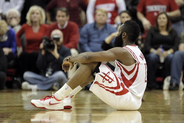 Mar 9, 2014; Houston, TX, USA; Houston Rockets shooting guard James Harden (13) sits on the court in reaction to a play during the fourth quarter against the Portland Trail Blazers at Toyota Center. Mandatory Credit: Andrew Richardson-USA TODAY Sports