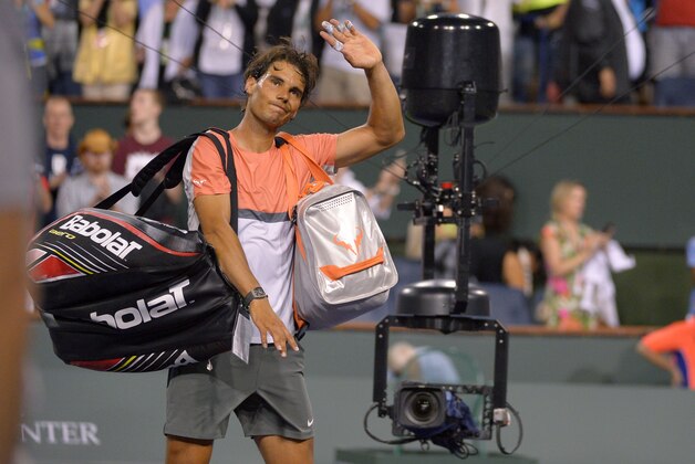 Rafael Nadal, of Spain, waves to fans after losing to Alexandr Dolgopolov, of Ukraine, at the BNP Paribas Open tennis tournament, Monday, March 10, 2014, in Indian Wells, Calif. Dolgopolov won 6-3, 3-6, 7-6 (5). (AP Photo/Mark J. Terrill)