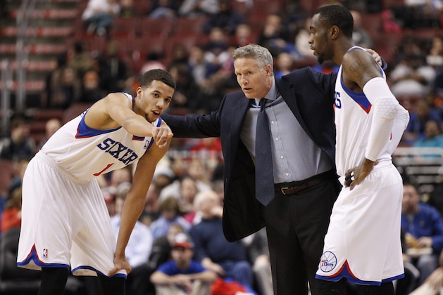 Philadelphia 76ers' Michael Carter-Williams, left, points things out to head coach Brett Brown, center, and Tony Wroten , right, during the first half of an NBA basketball game against the Milwaukee Bucks, Monday, Feb. 24, 2014, in Philadelphia. The Bucks won 130-110. (AP Photo/Chris Szagola)