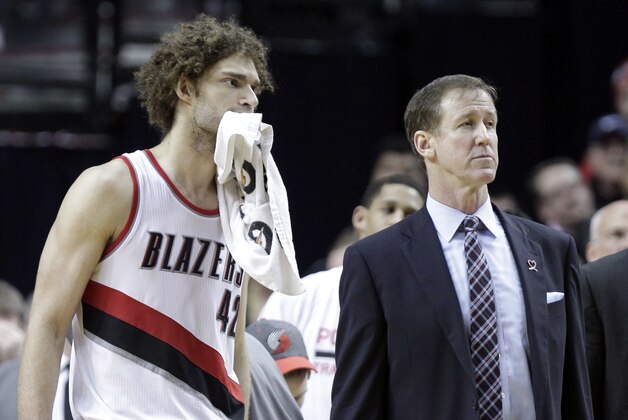 Portland Trail Blazers center Robin Lopez, left, and coach Terry Stotts watch as they lose the review on an out-of-bounds call late in the second half of an NBA basketball game against the Oklahoma City Thunder in Portland, Ore., Tuesday, Feb. 11, 2014.  The Thunder won 98-95. (AP Photo/Don Ryan)