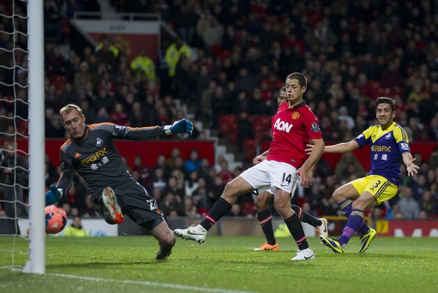 Manchester United's Javier Hernandez, centre right, scores past Swansea City's goalkeeper Gerhard Tremmel, left, during their English FA Cup third round soccer match at Old Trafford Stadium, Manchester, England, Sunday, Jan. 5, 2014. (AP Photo/Jon Super)