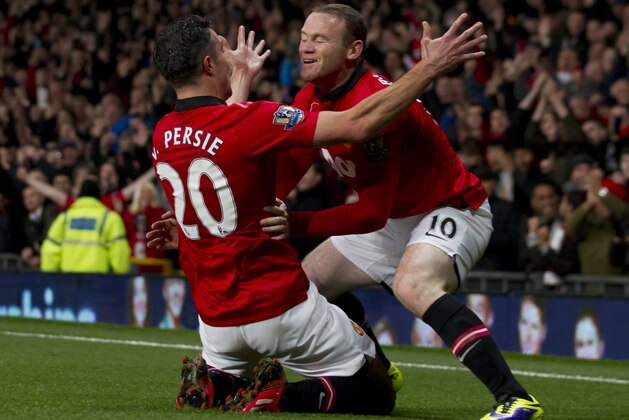 Manchester United's Robin van Persie, left, celebrates with teammate Wayne Rooney after scoring against Arsenal during their English Premier League soccer match at Old Trafford Stadium, Manchester, England, Saturday Nov. 10, 2013. (AP Photo/Jon Super)